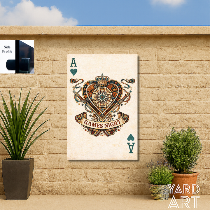 Decorative wall art with 'GAMES NIGHT' design on a stone wall with plants.