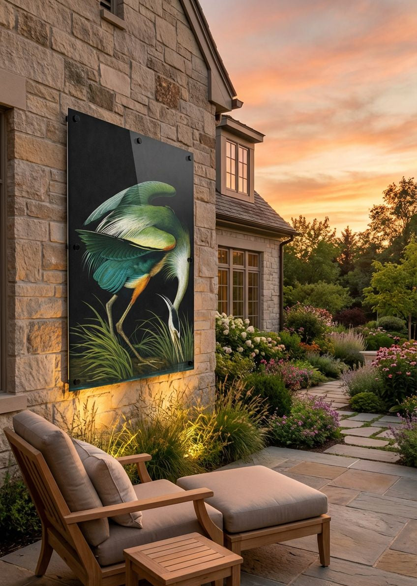 Outdoor patio with a decorative wall art piece of a green leafy plant, wooden chairs, and a sunset.