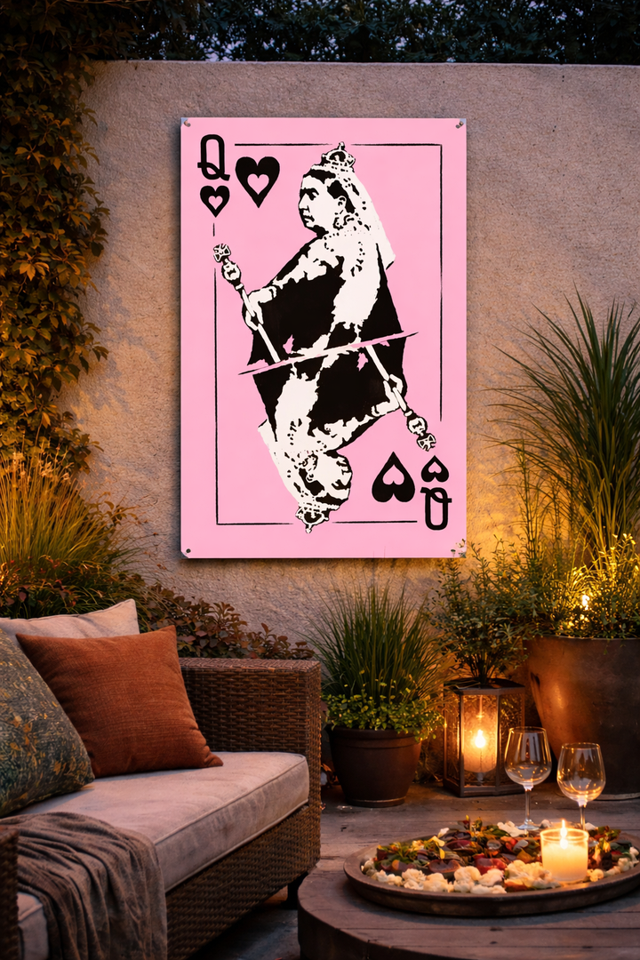 Outdoor Wall art print of a playing card design on a wall in an outdoor setting with plants and a couch.