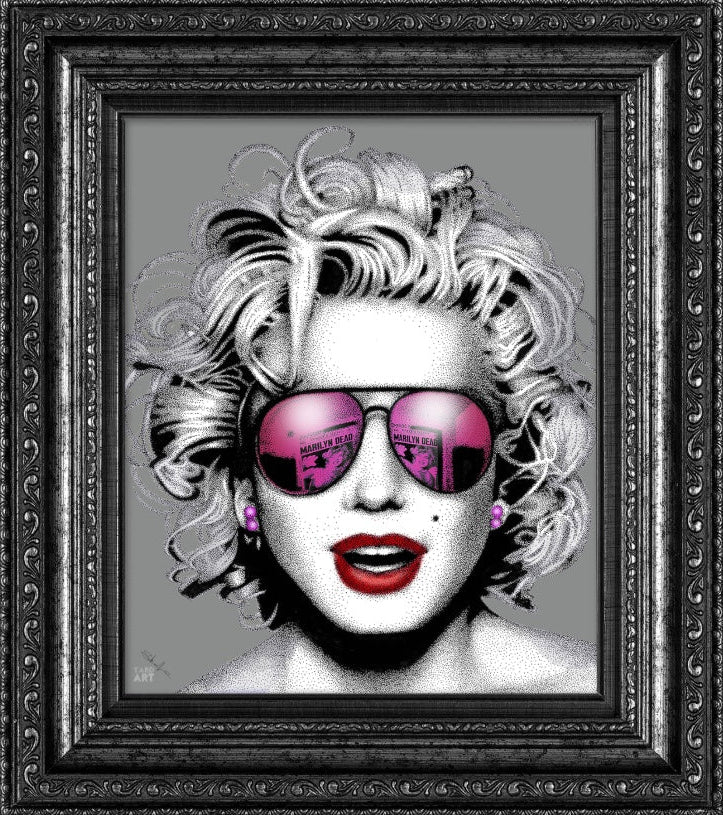 An acrylic print featuring a stylized, artistic representation of a woman's face with sunglasses, set against a black and pink blurred background.