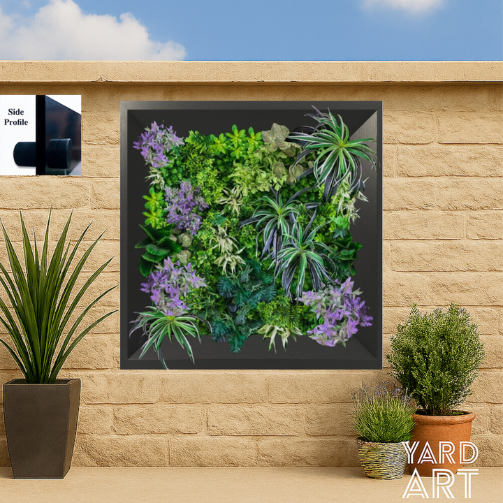 Framed vertical garden on a stone wall with potted plants around